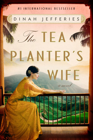 a book cover with a mountainous background and palm trees with a woman sitting leaning on a porch railing and the text the Tea Planter's Wife a novel by Dinah Jefferies