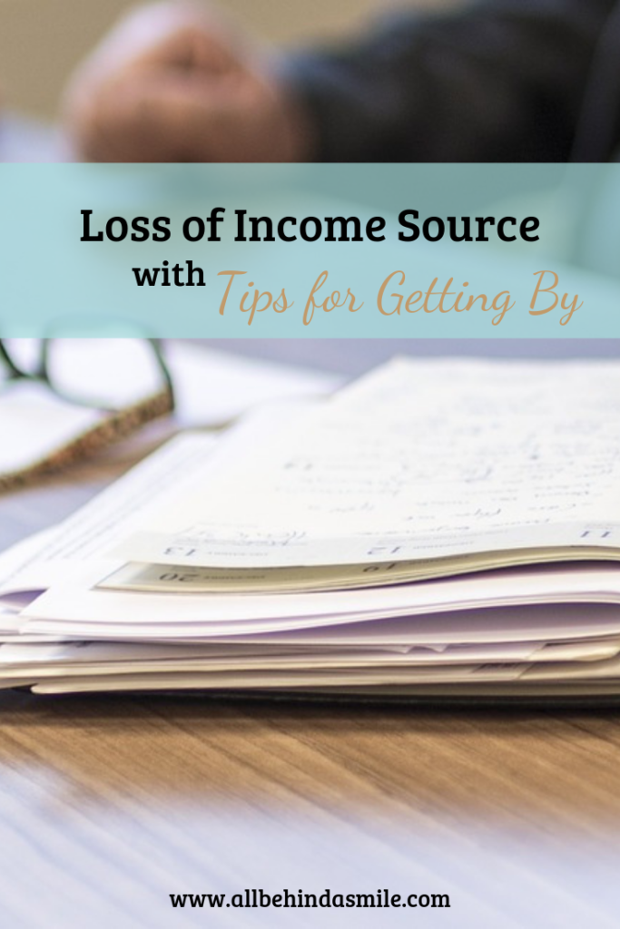 Loss of income source with tips for getting by over image of open book and glasses.
