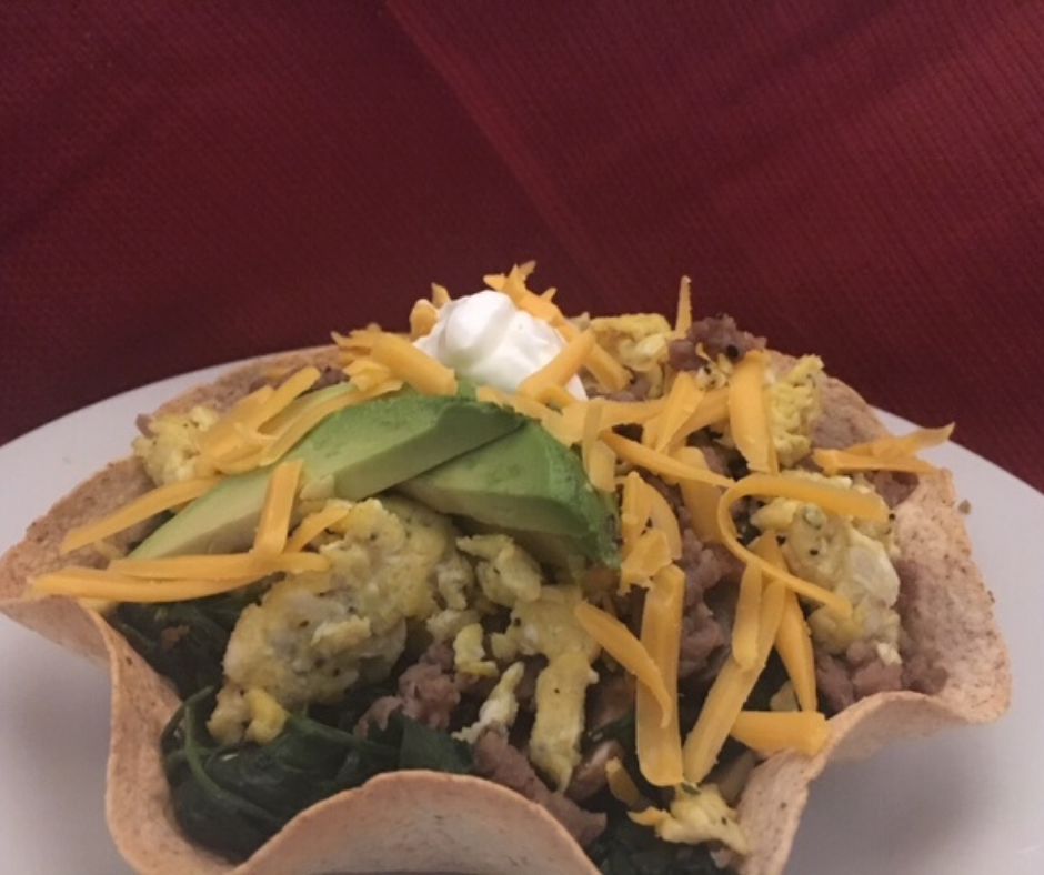 Breakfast Taco Bowls on a white plate with a red background