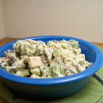 Sweet and Savory Broccoli Salad in a deep blue bowl on a green folded placemat
