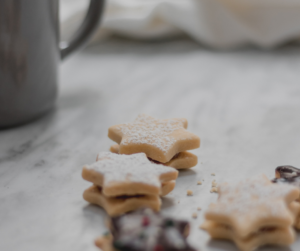 Star shaped cookies stacked on a dimly lit background