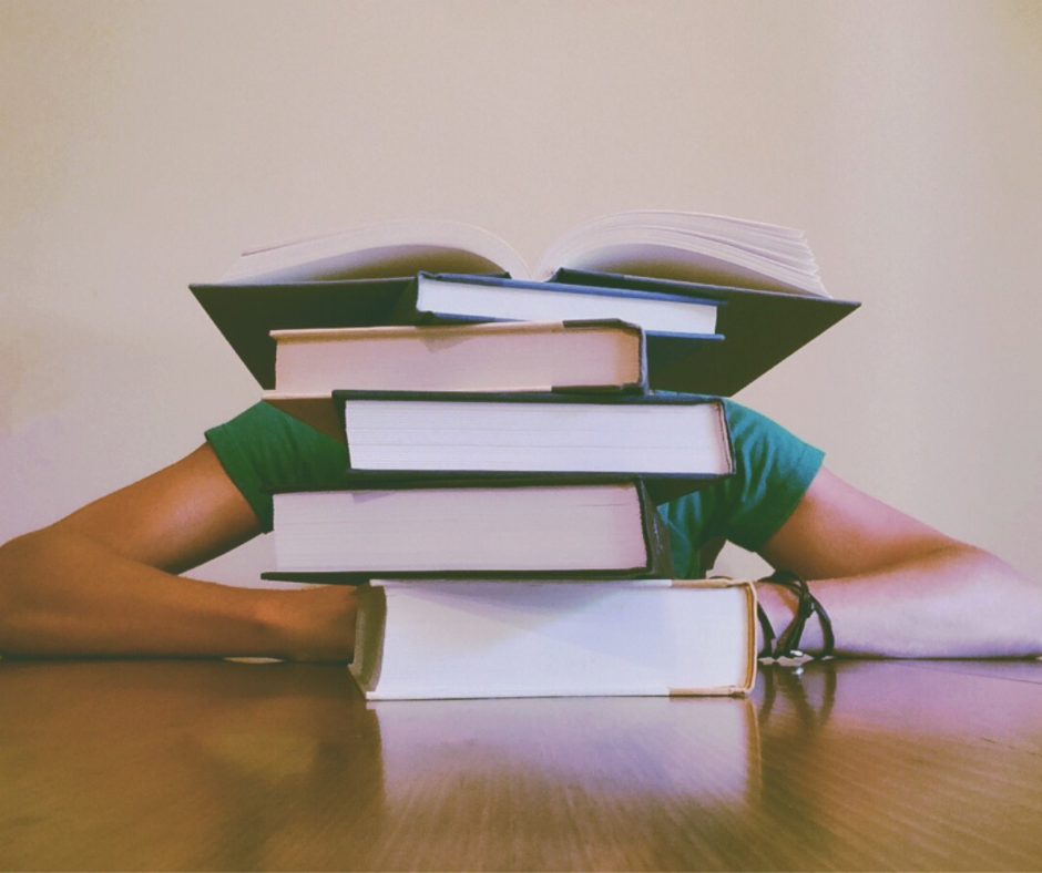 Stack of books with one book open on the top