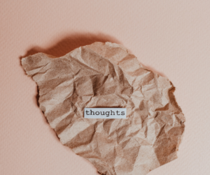 crumpled brown paper on a pink background