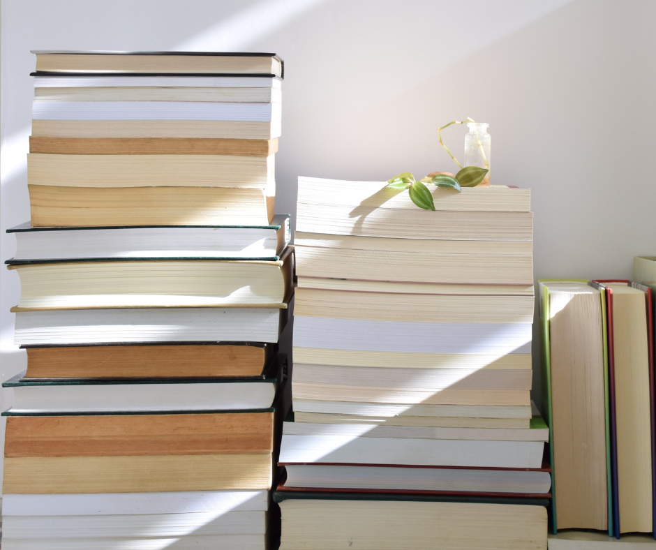 Piles of books with the spines not visible on a light colored background