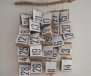 Numbered advent bags hanging on a branch