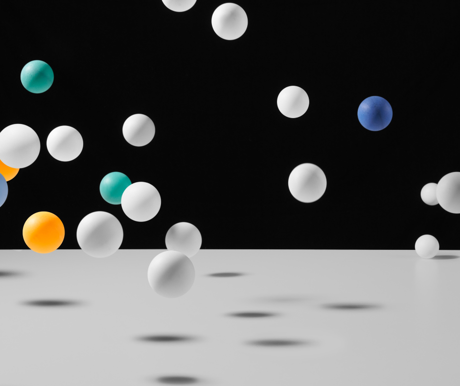 Ping pong balls bouncing on a white table with black background