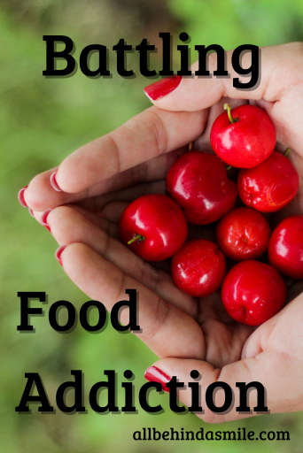 hands holding red berries over a green background