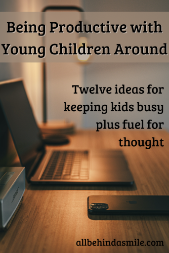 Image of a laptop and phone on desk with the text being productive with young children around twelve ideas for keeping kids busy plus fuel for thought