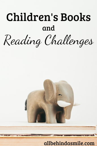Wooden grey elephant on two stacked books with the text "Children's Books and Reading Challenges allbehindasmile.com"