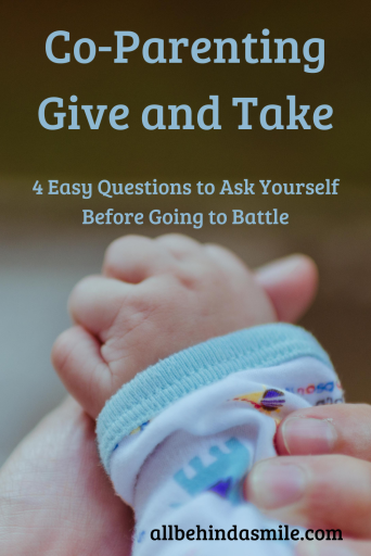 Baby hand in a parent's hand with a blurry greenish background with text: co-parenting give and take, 4 questions to ask yourself before going to battle