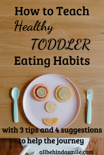 Image of a plastic plate of fruit arranged in a face shape with the text how to teach healthy toddler eating habits with 3 tips and 4 suggestions to help the journey
