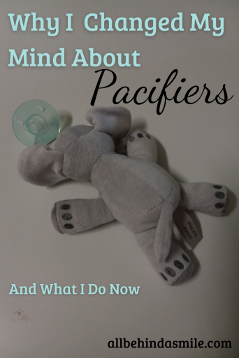 A blue pacifier with a grey elephant stuffed animal attached and text: Why I changed my mind about pacifiers and what I do now