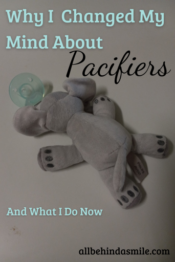 Pacifiers Changed My Mind A blue pacifier with a grey elephant stuffed animal attached and text: Why I changed my mind about pacifiers and what I do now