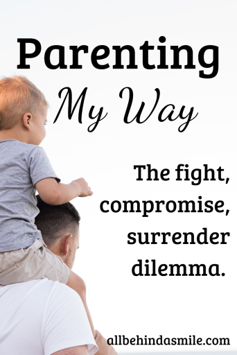 Blonde toddler boy in light blue shirt and tan shorts sitting on man in light colored shirt's shoulders with white background with text Parenting my Way: the fight, compromise, surrender dilemma