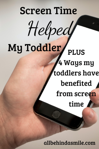 Screen Time Helped My Toddler Image of a hand holding a cell phone with a white screen and the text screen time helped my toddler plus 4 ways my toddlers have benefited from screen time
