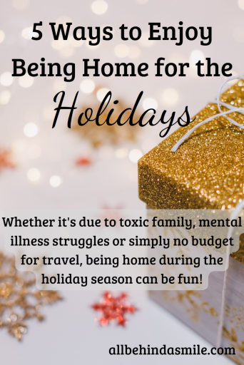 Glittery gold lidded present tied with twine and surrounded with gold snowflakes with the text 5 ways to enjoy being home for the holidays whether it's due to toxic family, mental illness struggles or simply no budget for travel, being home during the holiday season can be fun!